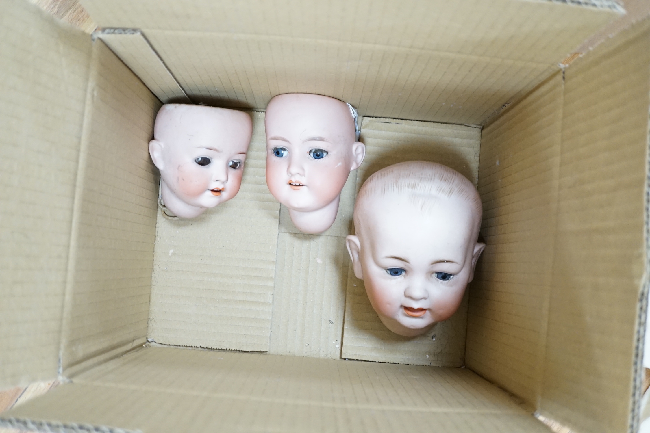 A Heubach doll and five bisque doll’s heads